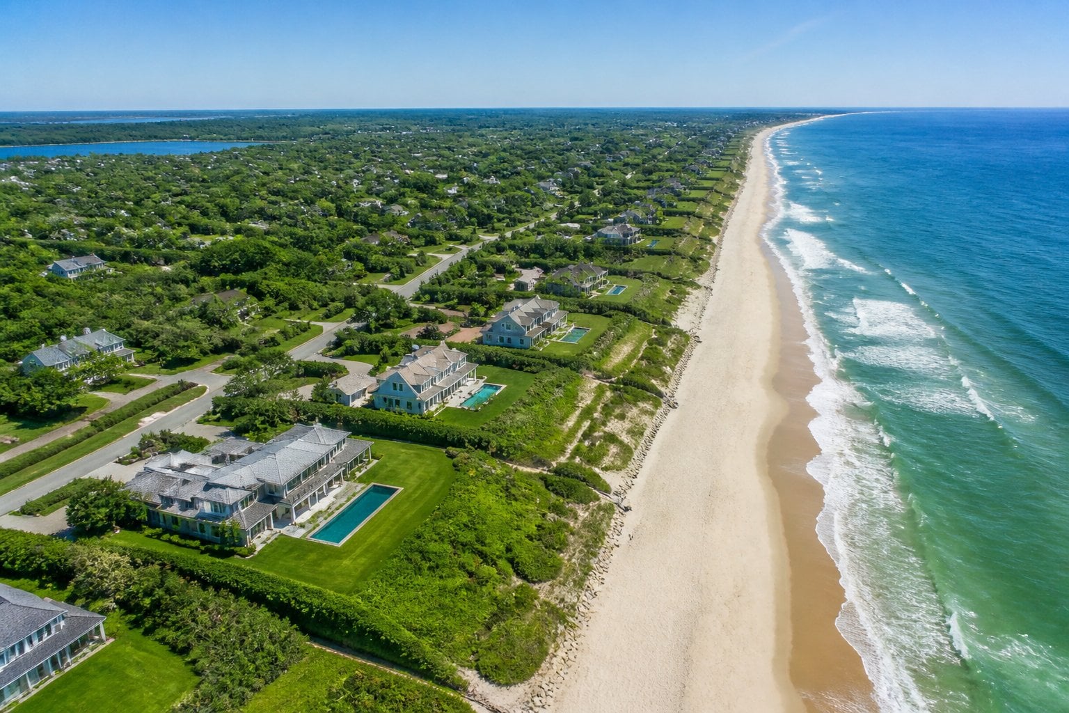 Aerial view of luxurious beachfront homes and sandy beaches along the Atlantic Ocean in East Hampton, New York.